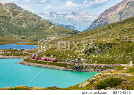 Bernina Express at the White Lake in Ospizio Bernina Express at the White Lake in Ospizio 68764836
