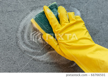 Woman's hands in yellow gloves cleaning counter top in kitchen Woman's hands in yellow gloves cleaning counter top in kitchen 68766501