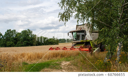 Modern harvester at work in field during wheat 68766655