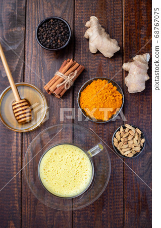 Turmeric moon milk in glass cup, ingredients Turmeric moon milk in glass cup, ingredients 68767075