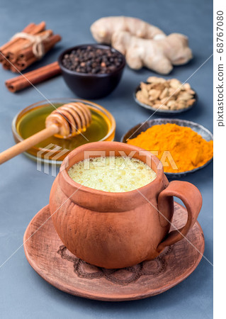 Yellow moon milk with turmeric in clay cup Yellow moon milk with turmeric in clay cup 68767080