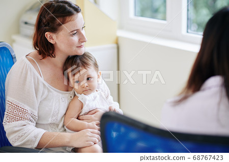 Woman listening to recommendations of pediatrician Woman listening to recommendations of pediatrician 68767423