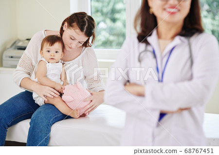 Mother and daughter at doctors office 68767451