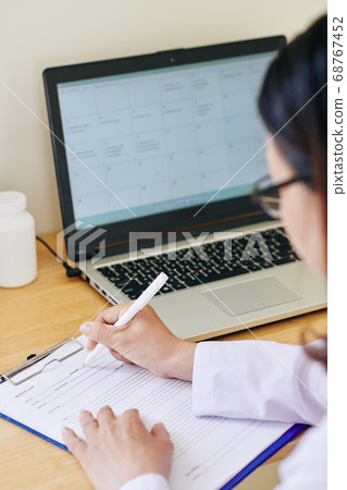 Doctor filling medical history Doctor filling medical history 68767452