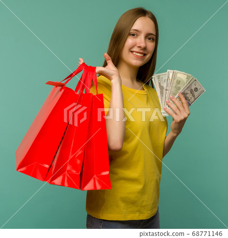 Photo of cheerful young woman holding fan of money Photo of cheerful young woman holding fan of money 68771146