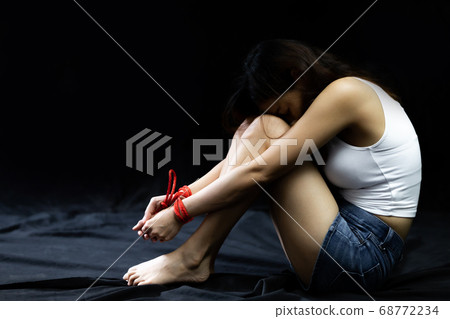 Victim women tied up with red rope 68772234