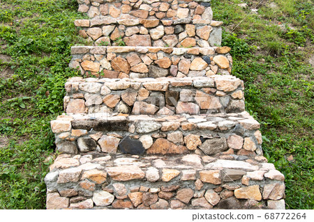Stone staircase upward on green grass background Stone staircase upward on green grass background 68772264