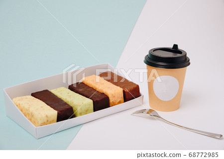 Set of cakes in icing and chocolate on a light Set of cakes in icing and chocolate on a light 68772985