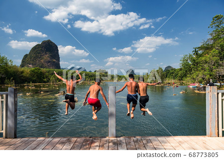 Happy friends jump to Klong Rood lake, Krabi 68773805