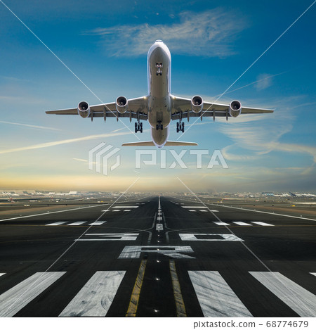 Airplane taking off from the airport runway 68774679