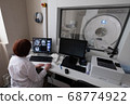 Professional Scientists Work in the Brain Research Laboratory. Neurologists Neuroscientists Surrounded by Monitors Showing CT, MRI Scans Having Discussions and Working on Personal Computers. 68774922
