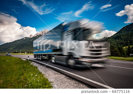 Fuel truck rushes down the highway in the 68775116
