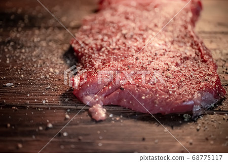 Mixed pepper and spices on the raw meat steak 68775117