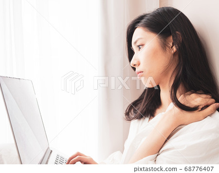 Young asian woman suffering from pain in shoulder Young asian woman suffering from pain in shoulder 68776407
