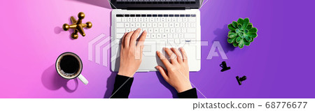 Woman using a laptop computer 68776677