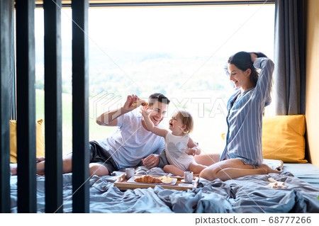 Young family with small daughter indoors, weekend away in container house in countryside. 68777266