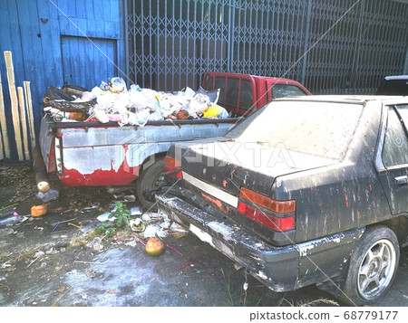 The Garbage in a  car on a street 68779177