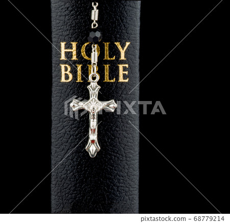 Bible Spine View with Crucifix on Black Background 68779214
