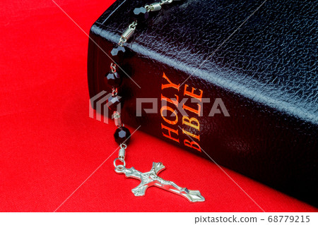 Bible and Crucifix on Red Canvas Surface 68779215