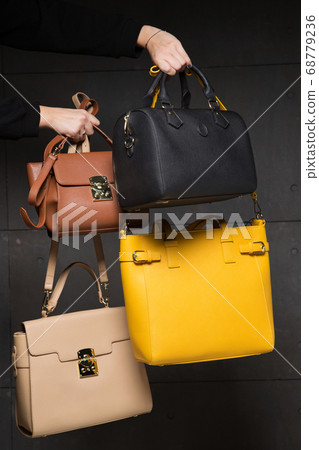 female hands holding bags, four fashion bags, 68779236