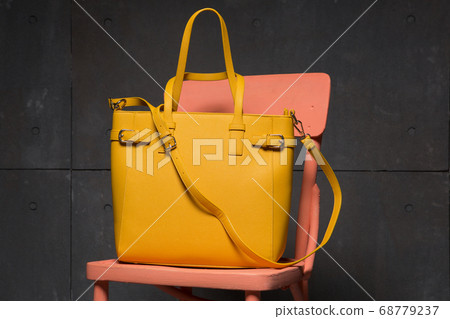 yellow fashion bag on a pink chair, shopping 68779237