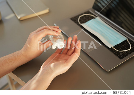 Unrecognizable Woman Sanitizing Hands at Workplace Unrecognizable Woman Sanitizing Hands at Workplace 68781064