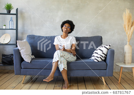 African American girl writes in a notebook in a cozy room 68781767