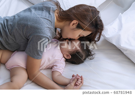 Young motherhood kissing her lovely daughter 68781948