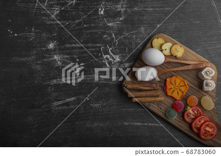 Snack board with chips, crackers and pastries on the wooden platter 68783060