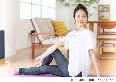 Young woman doing yoga in the room Young woman doing yoga in the room 68784862