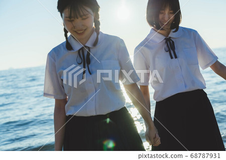 Schoolgirl in the sea at sunset Schoolgirl in the sea at sunset 68787931
