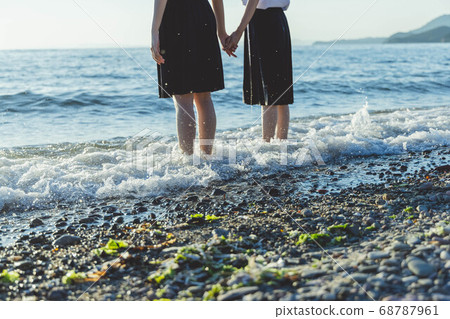 Schoolgirl in the sea at sunset Schoolgirl in the sea at sunset 68787961