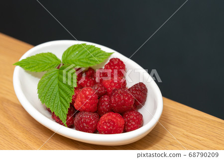 Plate of red raspberries (June) Plate of red raspberries (June) 68790209