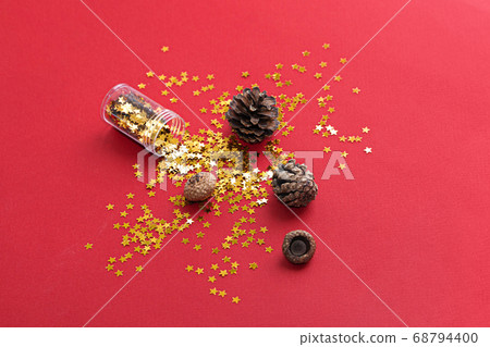 Vertical photo of golden star glitter on red background. Top view. Christmas background Vertical photo of golden star glitter on red background. Top view. Christmas background 68794400