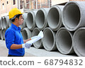 the worker is checking the stock of cement drain in construction site 68794832