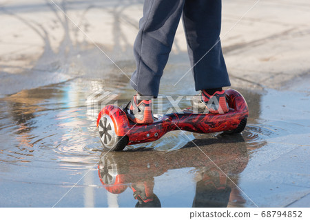 happy children ride on an electric giboard in the 68794852