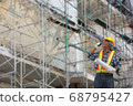 worker using walkie talkie to control team work in construction site 68795427