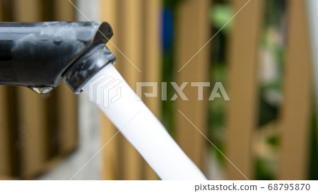 Jet streams of water running from a modern black Jet streams of water running from a modern black 68795870