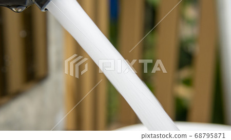 Jet stream of water running from faucet to wash Jet stream of water running from faucet to wash 68795871