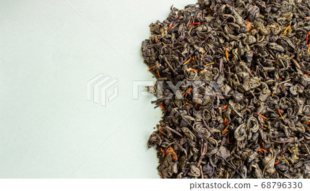 Dry green tea leaves on a light background. Empty 68796330