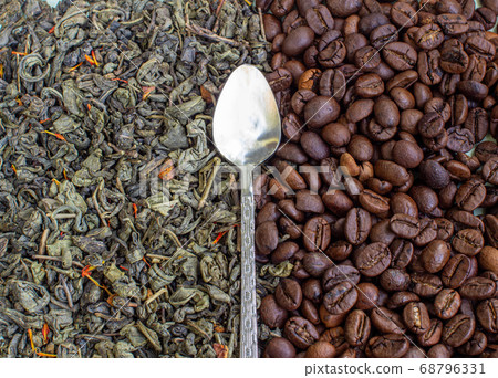 Dry green tea leaves and roasted coffee beans. 68796331