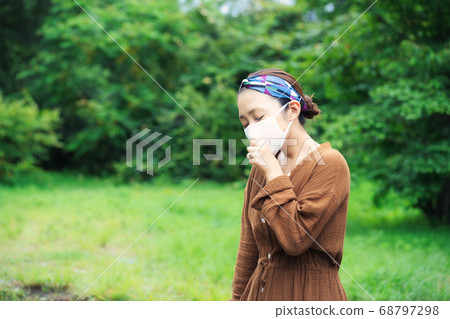 Woman wearing a mask outdoors Woman wearing a mask outdoors 68797298