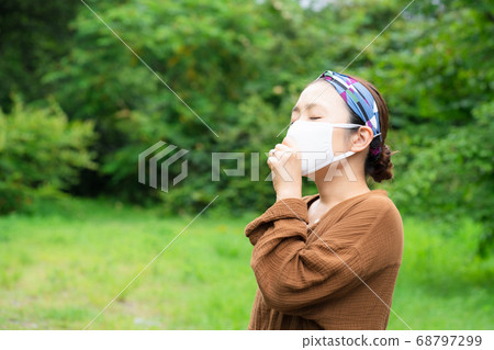 Woman wearing a mask outdoors Woman wearing a mask outdoors 68797299