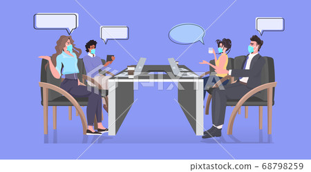 businesspeople in face masks discussing during conference meeting keeping distance to prevent coronavirus epidemic businesspeople in face masks discussing during conference meeting keeping distance to prevent coronavirus epidemic 68798259