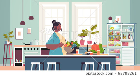 happy woman preparing healthy food at home cooking concept modern kitchen interior 68798261