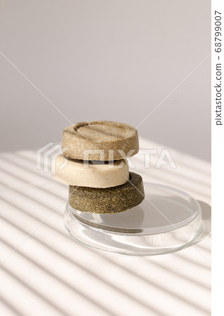 Three soap solid bars on striped shadow background. 68799007