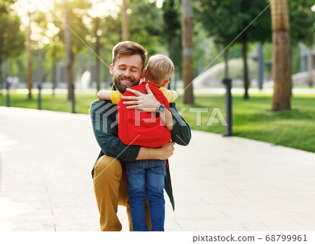 Happy son hugging father before school. Happy son hugging father before school. 68799961
