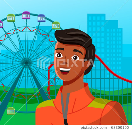 Young man near ferris wheel with colored cabins and a roller coaster ride amid large city buildings 68800100
