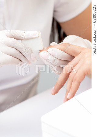 Close up of woman receiving manicure 68800228