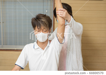Seniors receiving rehabilitation 68800570